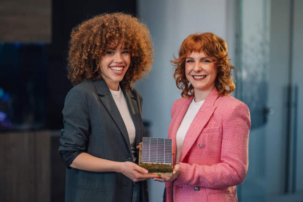 From Learner to Leader Two professional women holding award together